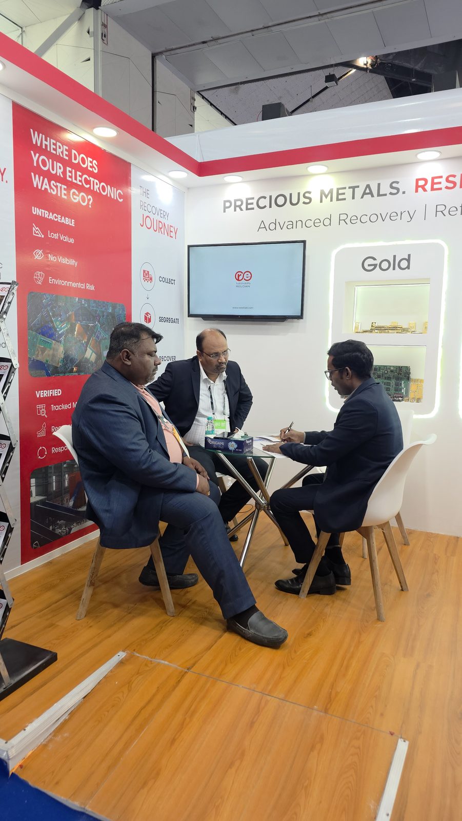 Visitors in conversation about e-waste recovery at IMC.