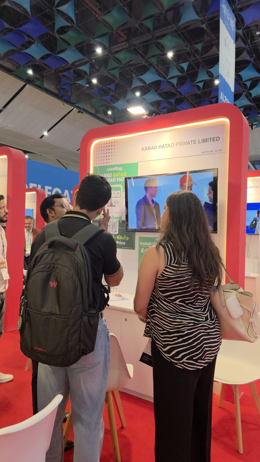 Guests watching the screen at booth AI-155.