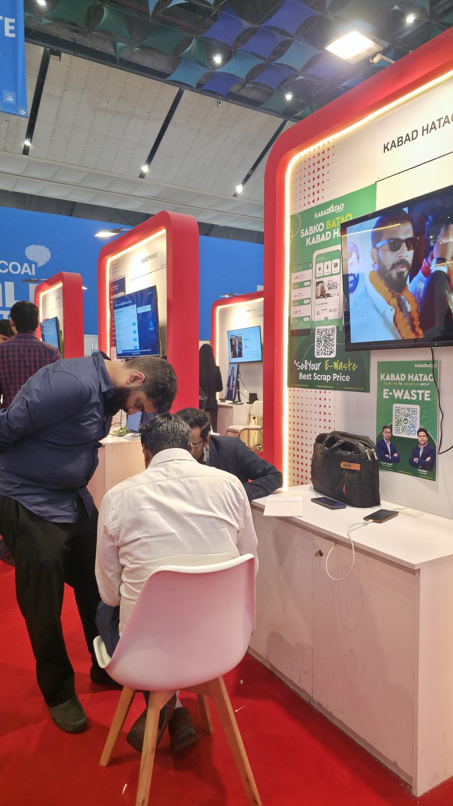 Visitors talking with the team at booth AI-155.