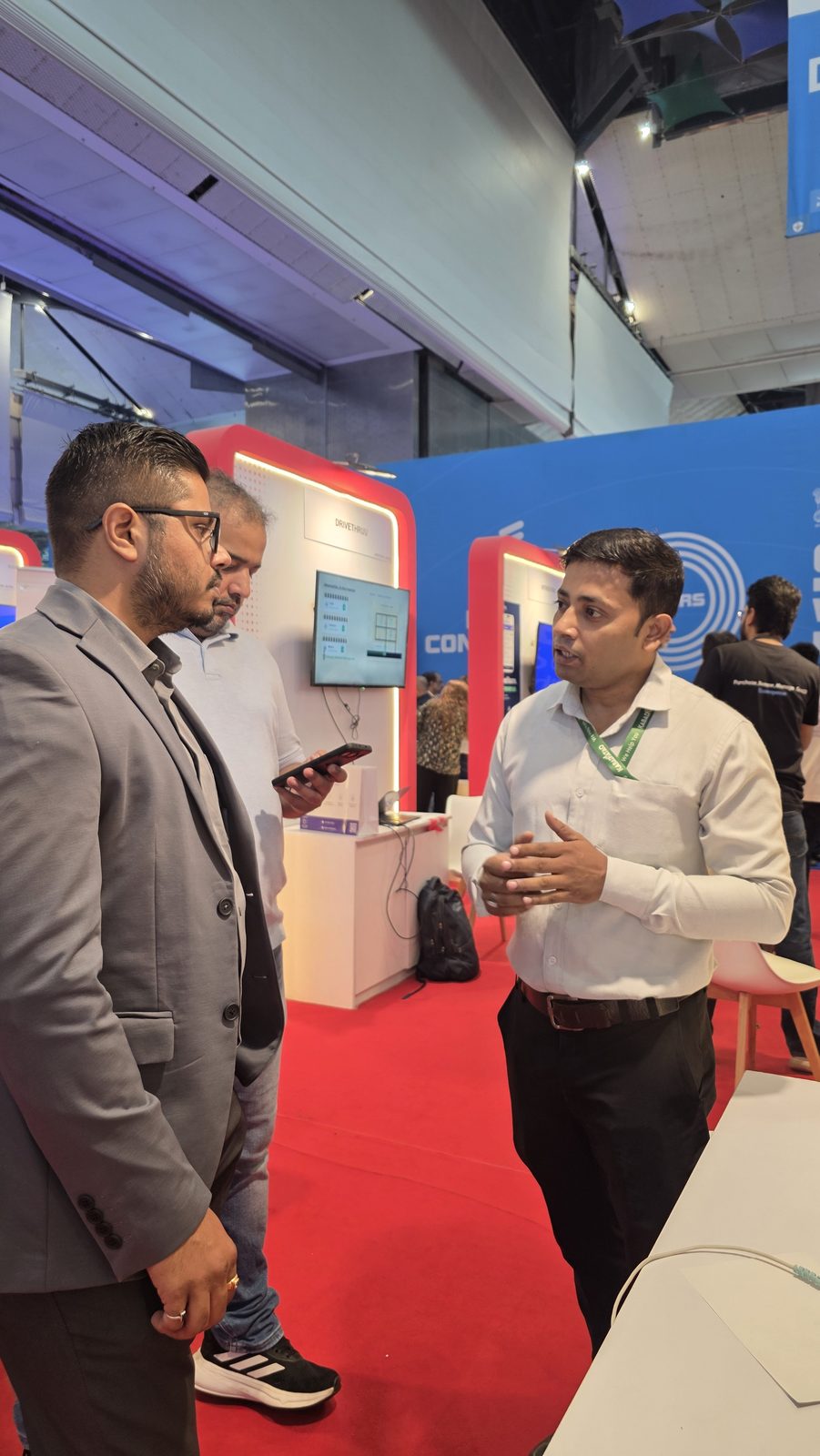 Visitors talking with the team at booth AI-155.