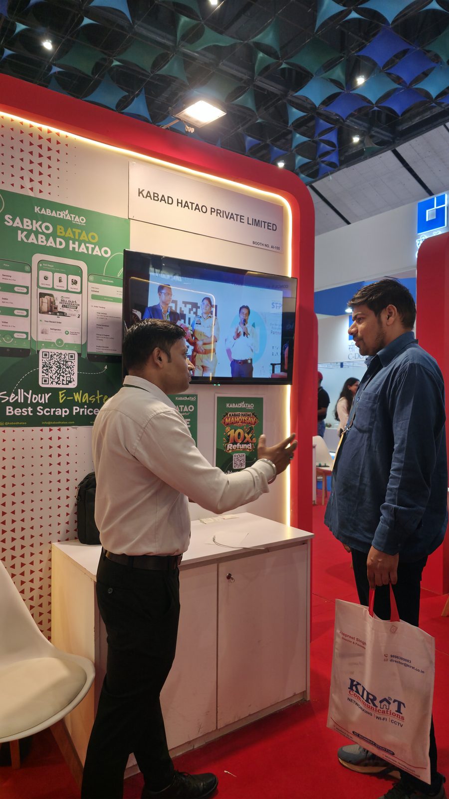 Visitors talking with the team at booth AI-155.