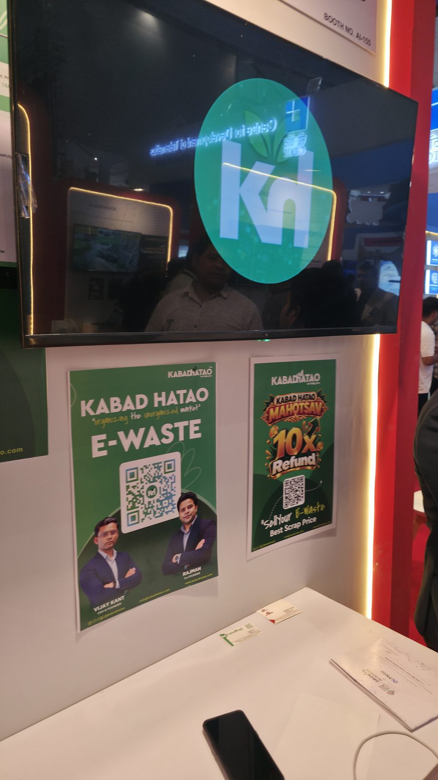 The stall screen and e-waste posters at booth AI-155.