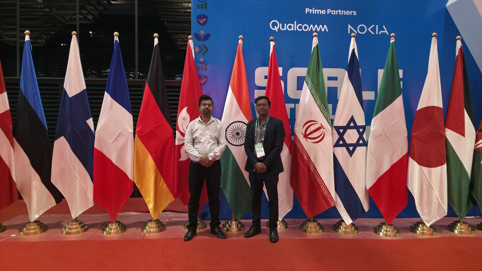 Teammates beside the flag display.