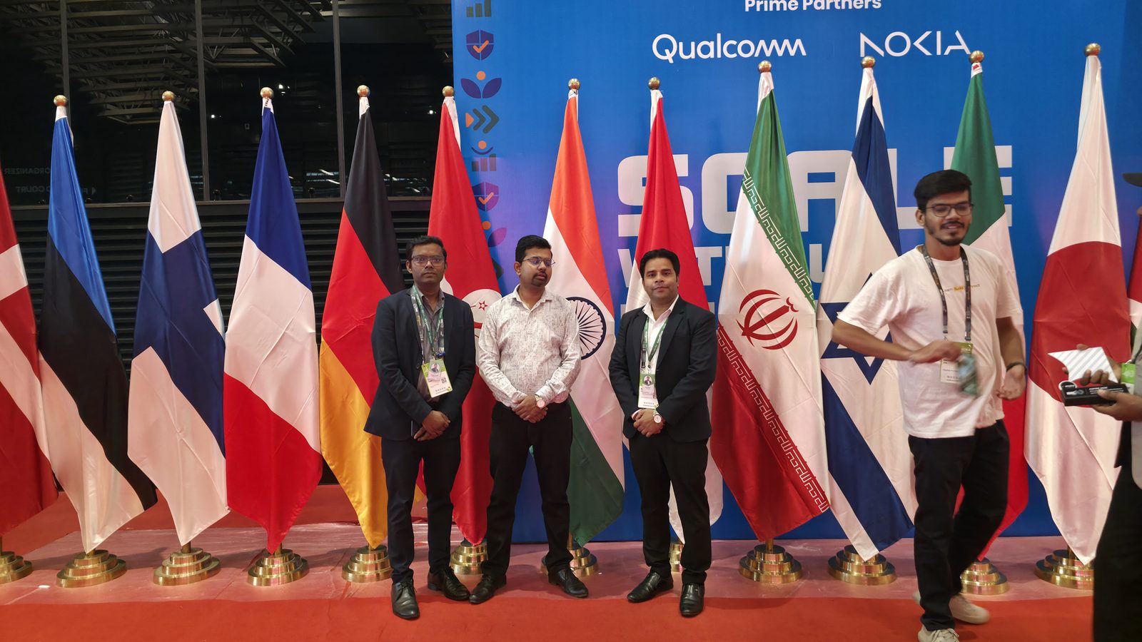 A group photo in front of the country flags.