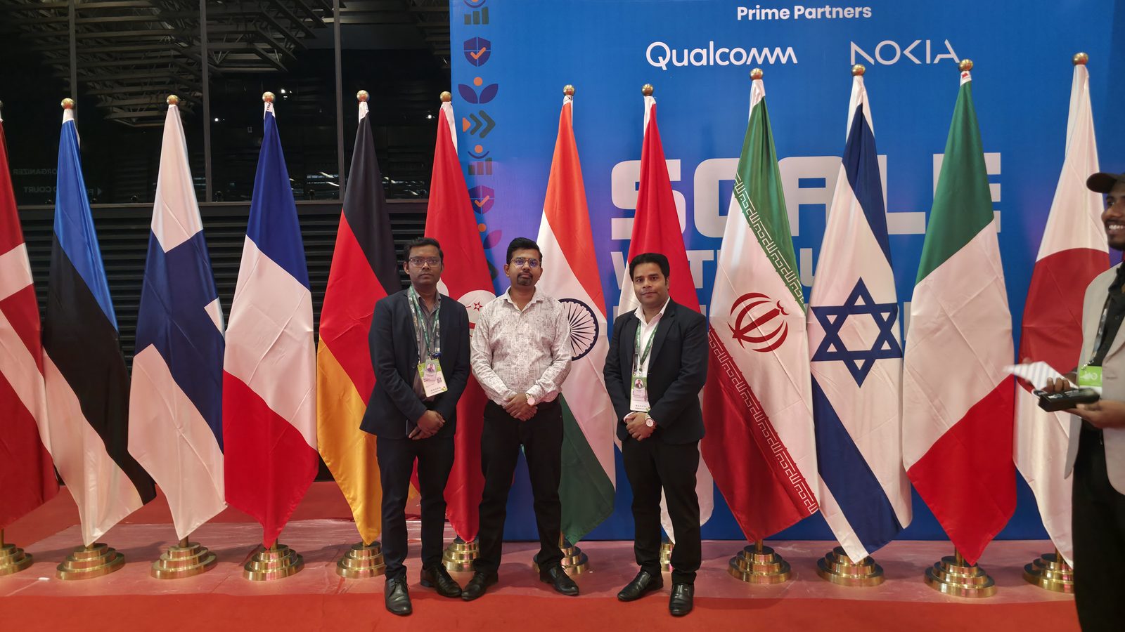 Teammates beside the flag display.