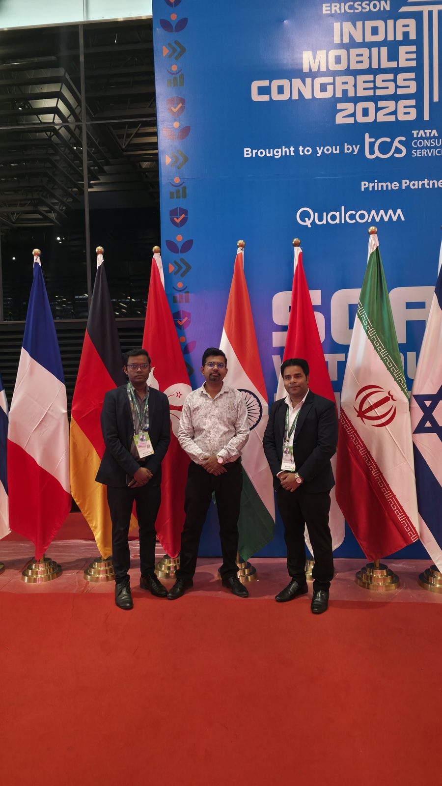 A group photo in front of the country flags.