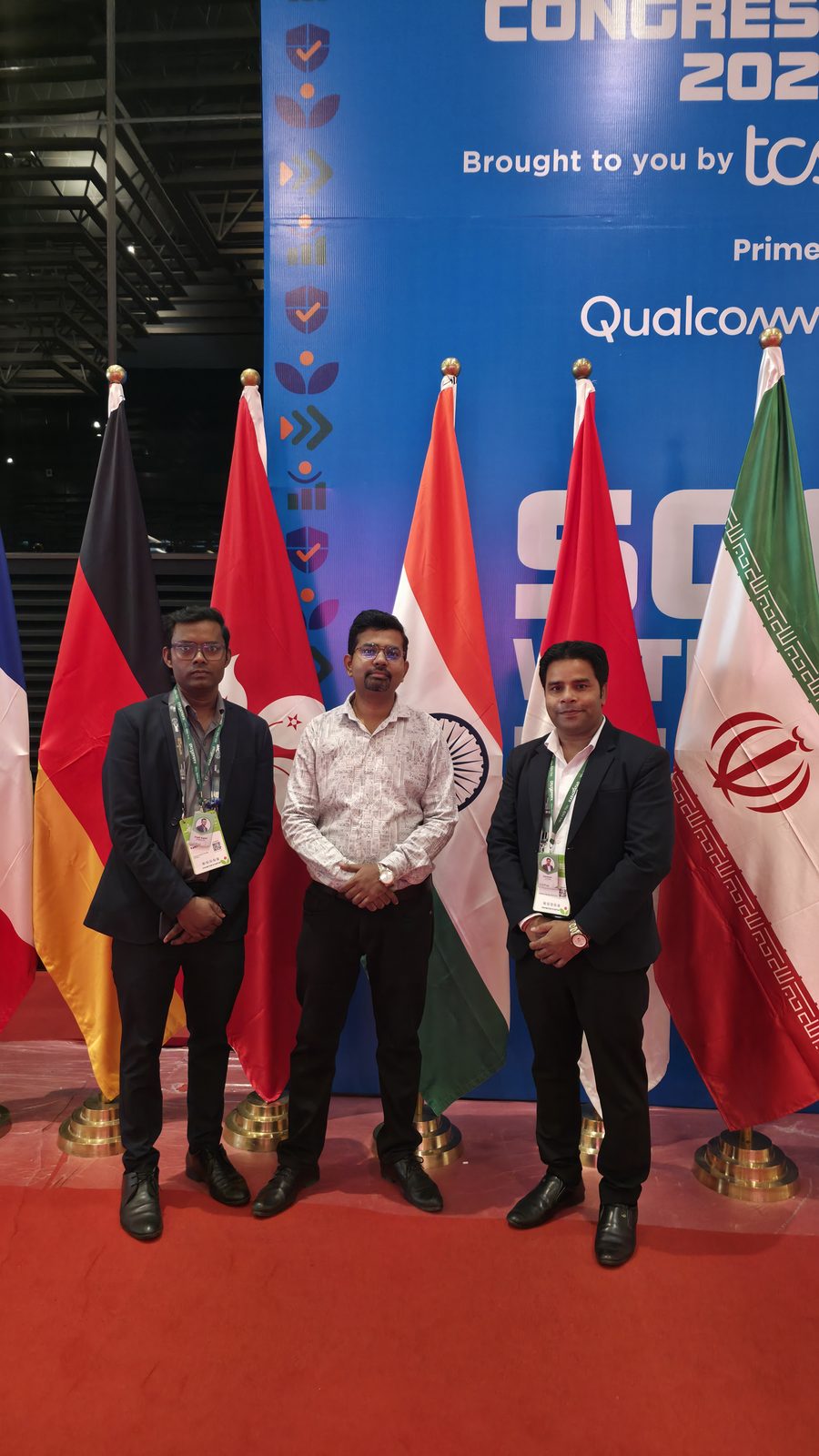 Teammates beside the flag display.