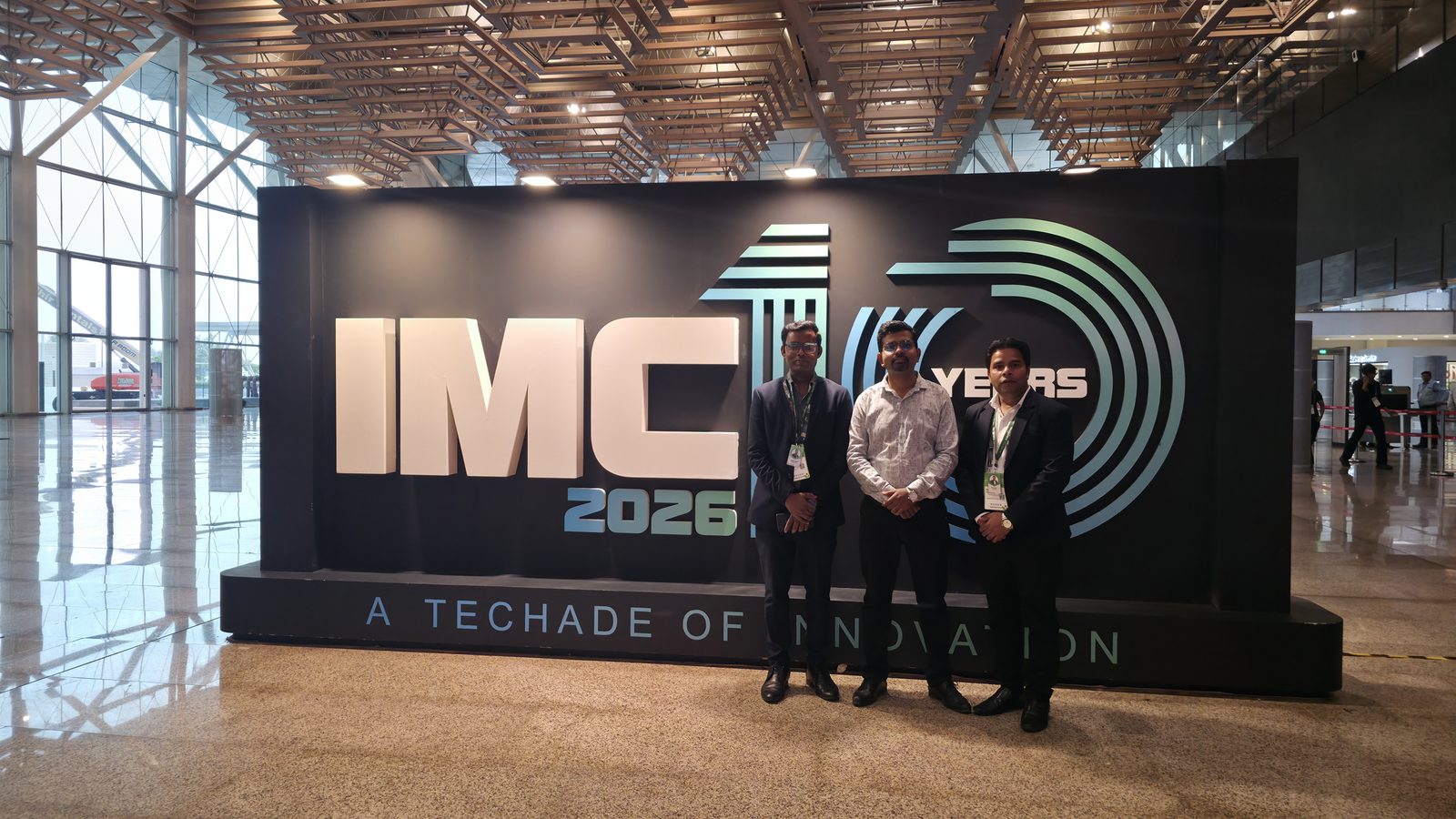 The team at the IMC 10 Years wall.